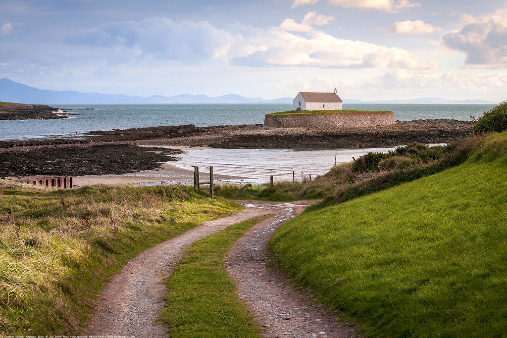 While the placement of "Eglwys Bach y Môr" (Little Church in the Sea) may seem perilous, it wasn't always so. St Cwyfan's was built at the end of a peninsula between two bays, Porth China and Porth Cwyfan.But the sea slowly eroded the coastline, and the peninsula was cut off.