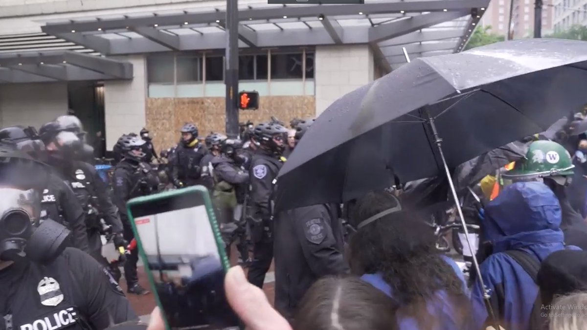 at 4:29 the Times links a short, two minute video, showing police in full body armor and gas masks arrayed sometimes back to back in ranks against protesters in helmets wielding umbrellas as makeshift shields, in a scene that quickly calls to mind the recurring Hong Kong Protests