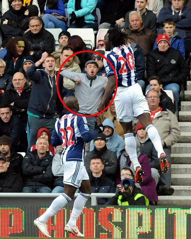 A Sunderland Fan makes a Monkey gesture facing towards Romelu Lukaku who as you can see is a black footballer.