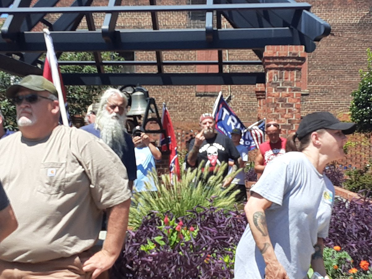 The cops and racists moved on me when I tried to photograph this Nazi in a hammerskins tshirt. You can see him flipping me off in the background. Cops threatened to arrest me multiple times, so this was the best I could do.