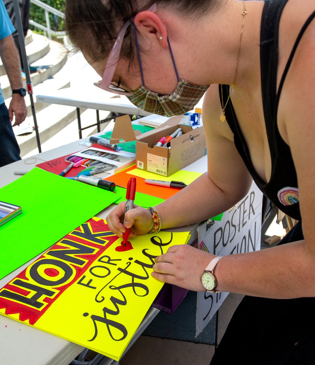 Hannah Shiff, 29, of Sherman Oaks, finishes a poster for people demonstrating against racial inequality and in support of Black Lives at the Sherman Oaks Galleria. She's lived here 7 years, and said she's never seen this much political activity here and welcomes the change.