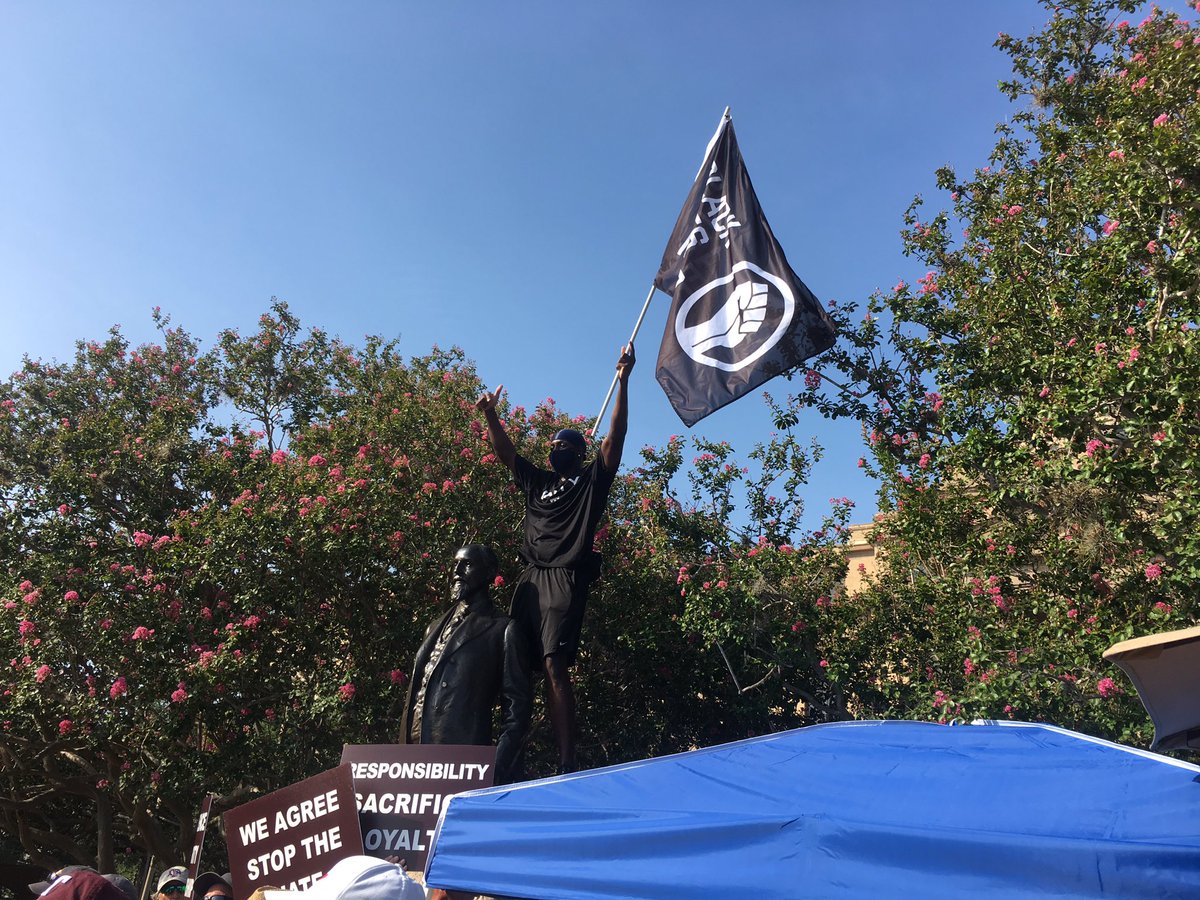 KennySWiley's tweet photo. Texas A&amp;M track student-athlete Infinite Tucker has climbed the “Sully” statue and draped it with a Black Lives Matter flag. https://t.co/MyPhSCiLVl