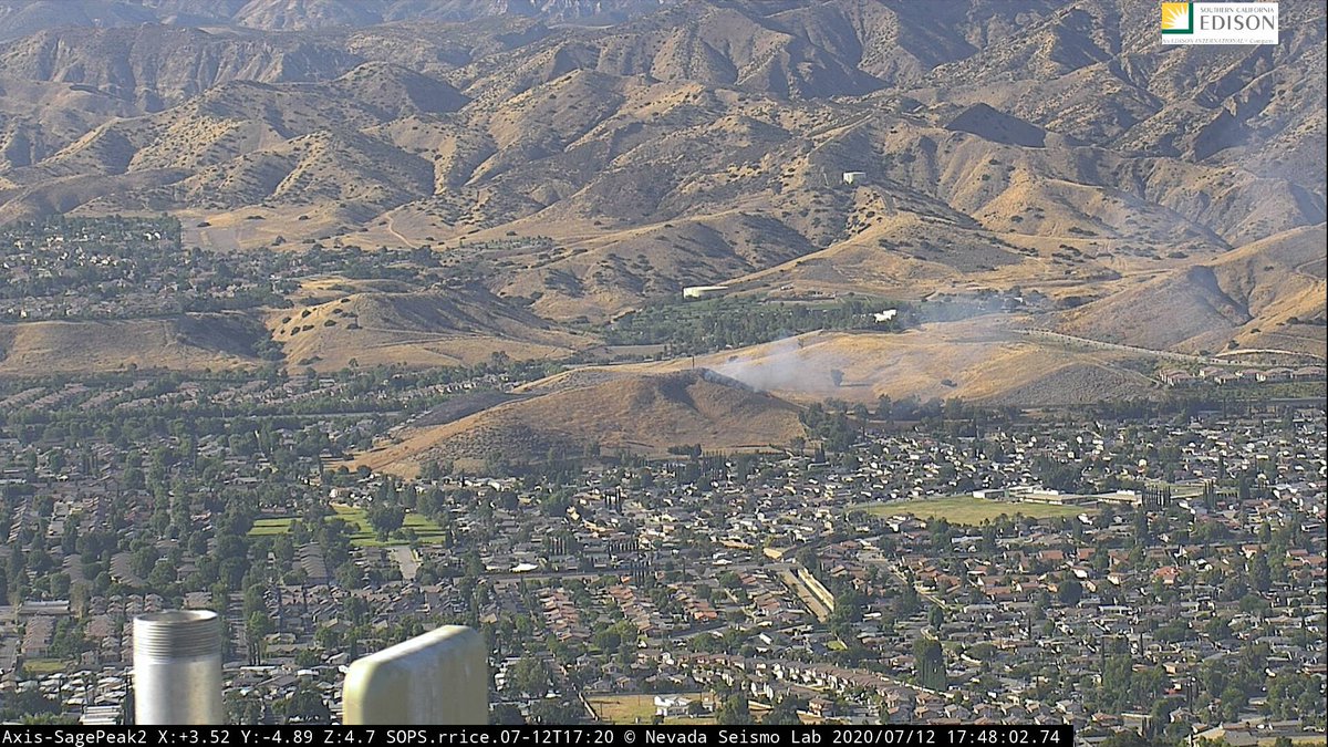 VCscanner's tweet photo. #CochranFire: Fire is slowly backing downhill towards homes. LA County Copter 18 on scene along with 2 copters from VC. Possible new brush fire in Tapo Canyon was possibly just a cloud or drift smoke. https://t.co/EinV896ju3
