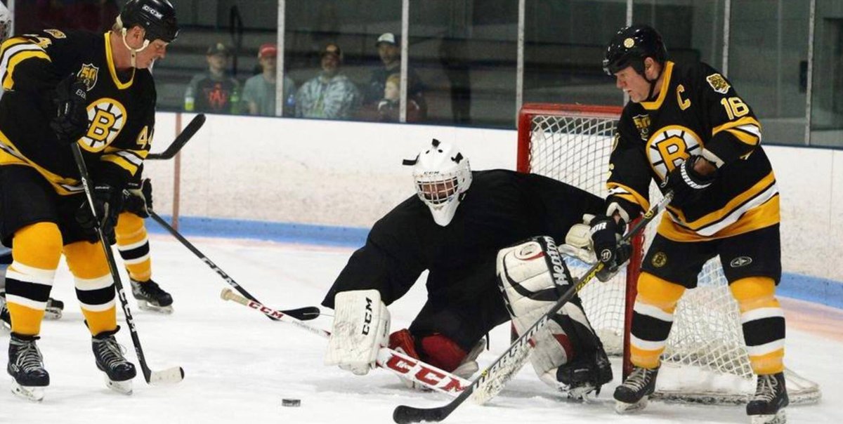David A. Jensen and Rick Middleton try to score in a 2018 Boston Bruins Alumni game in Rockland, MA.