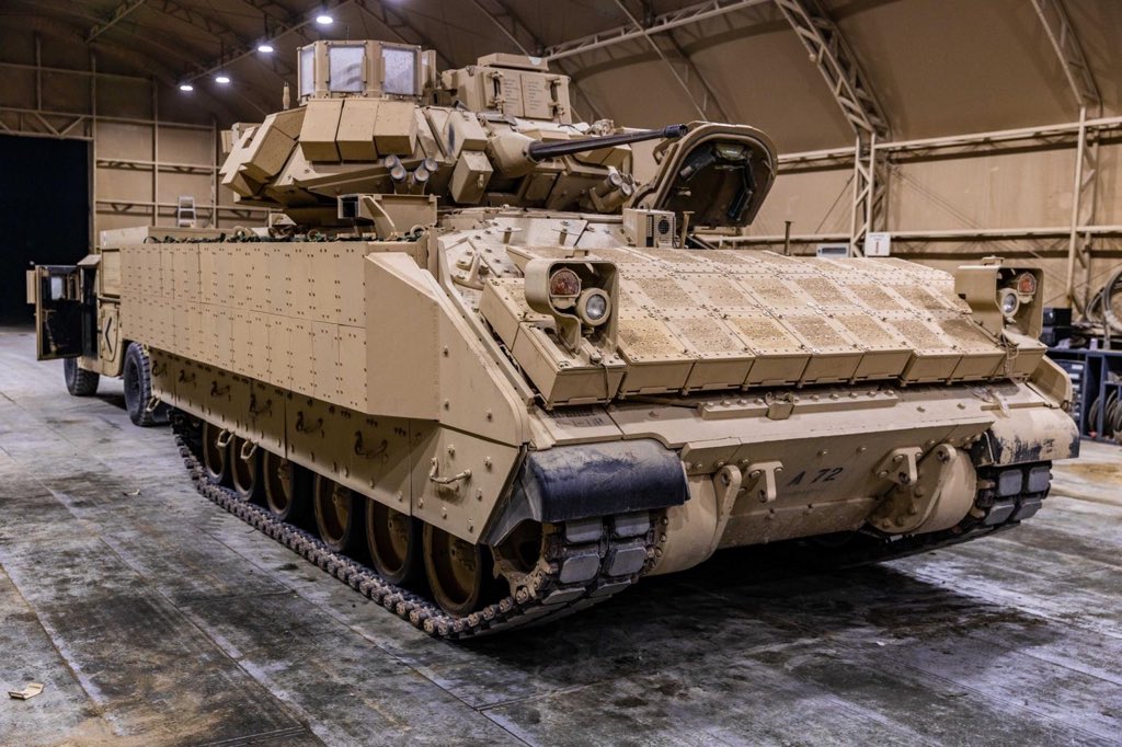 30thabct's tweet photo. U.S. Soldiers from the 4-118th Infantry Regiment, #30thabct install Bradley Reactive Armor Tile (BRAT) on an M2 Bradley Infantry Fighting Vehicle to validate instillation requirements while deployed in the @CENTCOM area of responsibility for @TFSpartan, July, 2020. https://t.co/KvWCh7xiGQ