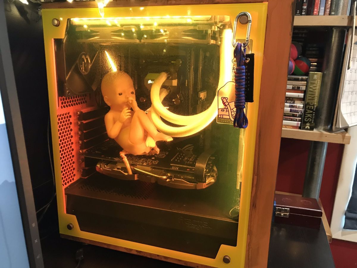 pcgamer's tweet photo. This Death Stranding PC build houses a toy baby, and it's both cute and nightmarish https://t.co/Xt9OFvbEV2 https://t.co/nDMbqlCMcZ