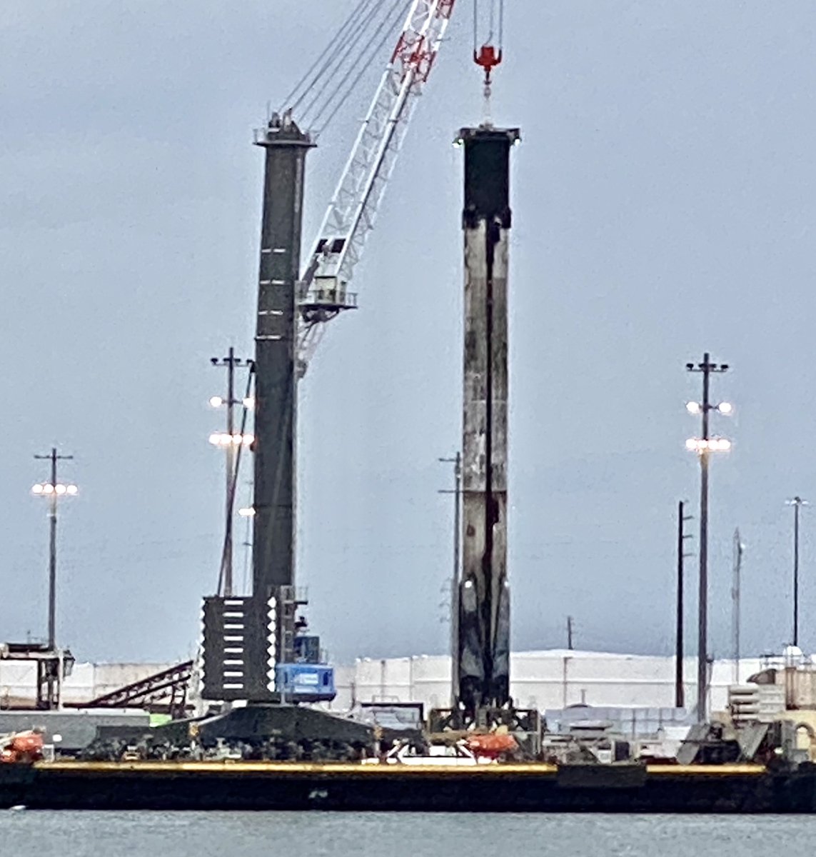 ken_kremer's tweet photo. Just stunning to see proud 2x launched/landed #falcon9 1st stage w all 4 legs retracted-under gloomy skies/torrential rain/thunder that halted work this afternoon @PortCanaveral.from #anasisII. This #spacex booster also 1st to launch humans from US in 9 yrs on its 1st flight https://t.co/bIiioE5EgI