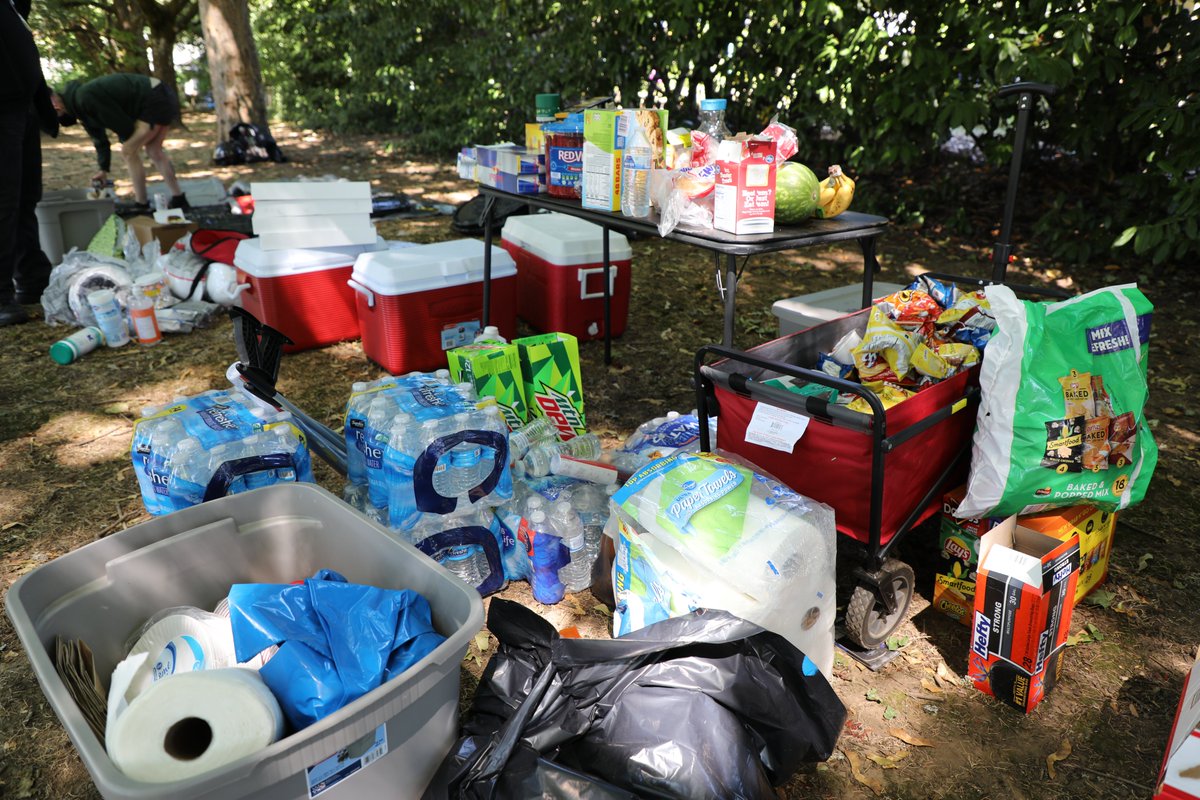 Using Twitter to coordinate, volunteers gather 3 times a week (location announced the night before) to build these shields. All materials – including duct tape, power tools and pool noodles – are donated (along with everything on this extremely packed snack and supply table).