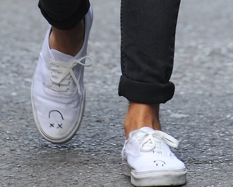 taking a moment to cry over his shoes in this picture. the little drawn smiley faces are so soft, i want him to draw smiles on all my shoes. anyways, his ankles look stunning here, nice and sun kissed. very healthy looking ankles here accentuated by the cuffed jeans, 100/10