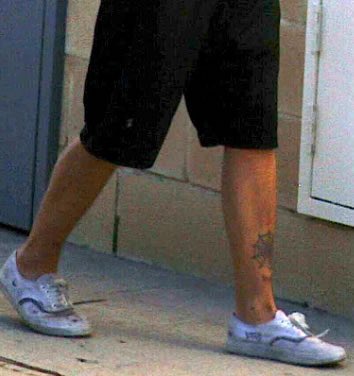 a lot more leg in this gem, exposing the spider web tattoo looking sick asf. i love how low cut flat shoes make his feet look so tiny aww! stance says he’s walking fairly fast, we love a man on the move. but, there’s no socks and since he’s outside his feet probably stink, 7/10