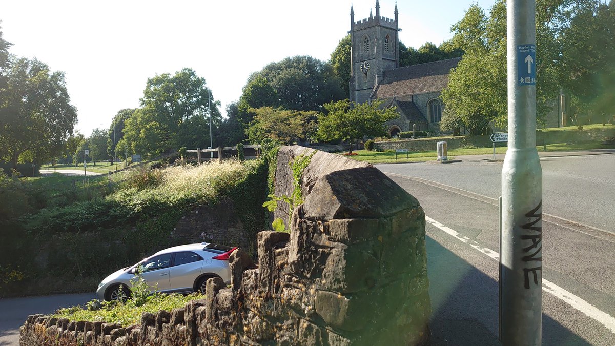 'civic sarsens' - these (plus some wooden bollards) were placed here quite recently in order to keep cars off the green. Anyway, what about that original southwest turn in the road after the church? It's still there, but is now a dead end, the road itself lying (8/24)