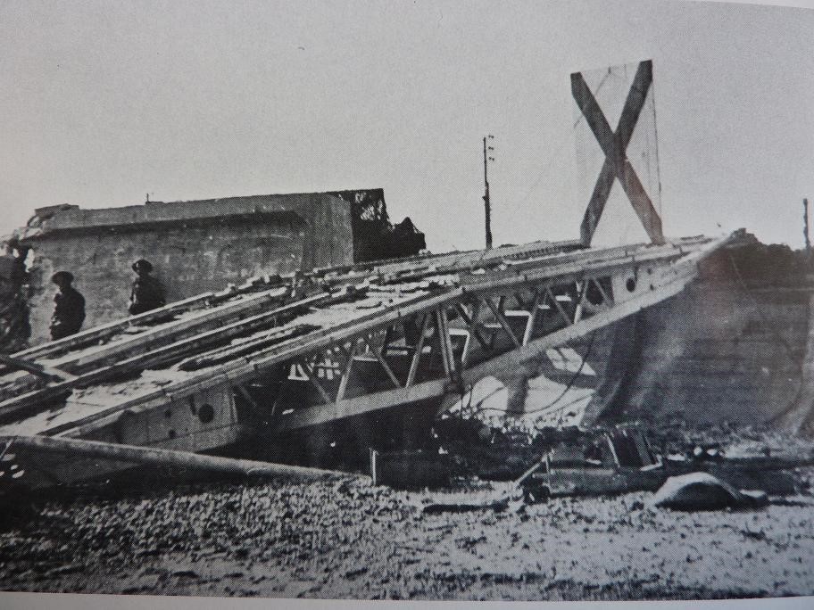 Lt Saunders saw there was no need for his log carpet and dropped it. Sgt Smith in the bridge AVRE (1E) followed the Crab and dropped his bridge against the wall. This is a picture of the bridge in place, and it can be seen in the famous first photo in the left-hand box. 5/12