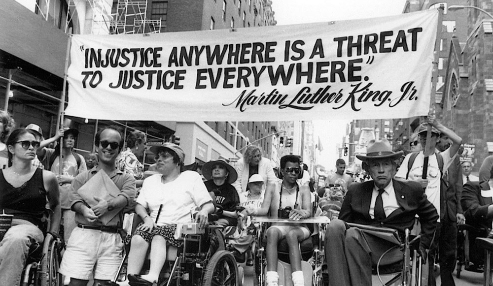 The Americans with Disabilities Act of 1990 moved America closer to its original promise of equality for all.It criminalized discrimination against disabilities. And, importantly, it required American buildings that were open to the public to become more accessible to everyone.