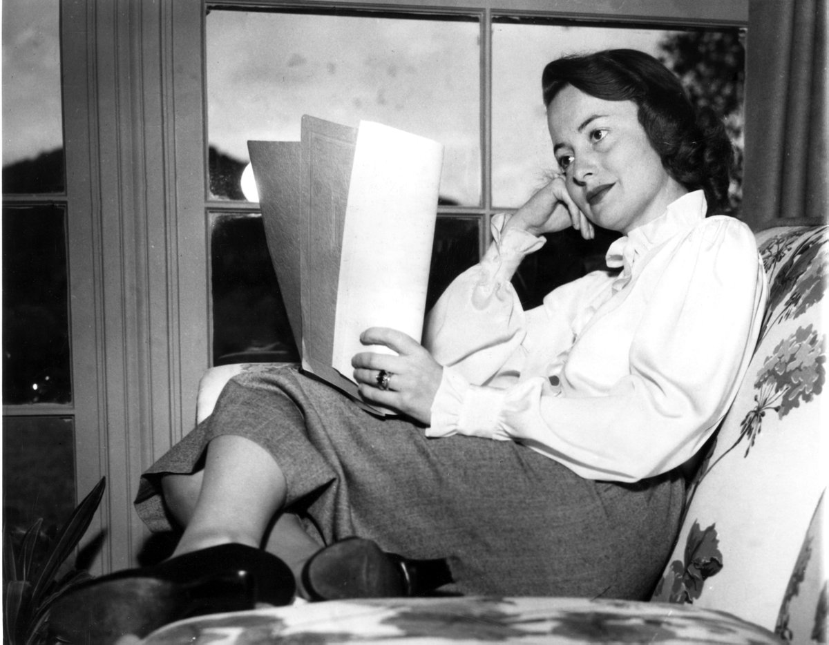 Olivia, at home in Beverly Hills, reading her script.