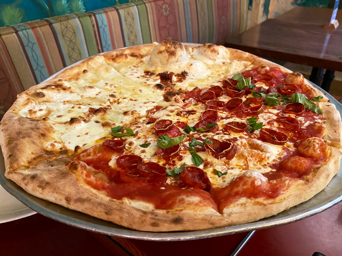 WDWNT's tweet photo. We got half four cheese and half pepperoni from Via Napoli. LOOK AT THAT BUBBLE! https://t.co/iqvOyzGafW