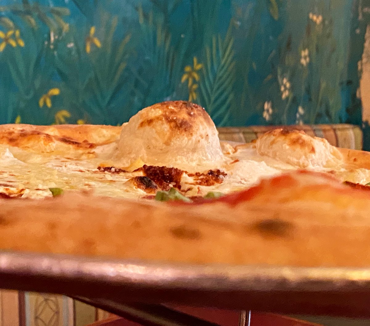 WDWNT's tweet photo. We got half four cheese and half pepperoni from Via Napoli. LOOK AT THAT BUBBLE! https://t.co/iqvOyzGafW