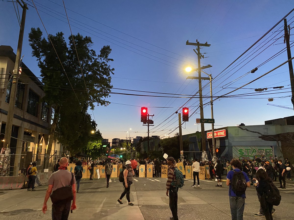 Omarisal's tweet photo. #ProtestSeattle - Protesters reconstitute their line and march to 12th and Pine next to the Seattle Police East Precinct. https://t.co/VuMtNERrgi