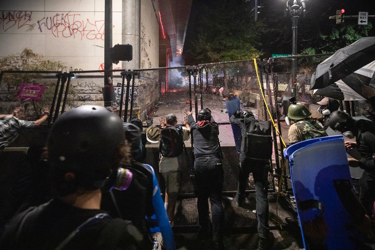 There were multiple attempts to pull the fence down on the north side of the building. At one point I heard that part of the south side fence came down. Around then, the feds came back out to clear the street.