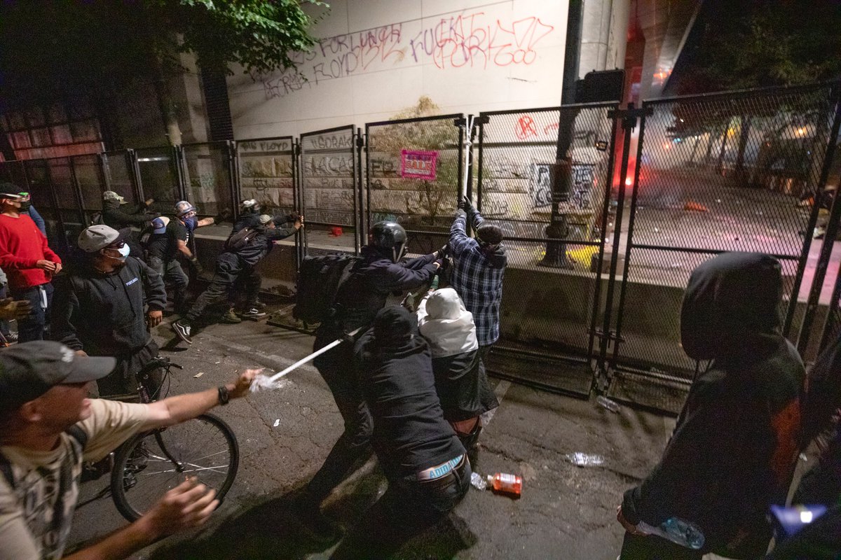 There were multiple attempts to pull the fence down on the north side of the building. At one point I heard that part of the south side fence came down. Around then, the feds came back out to clear the street.