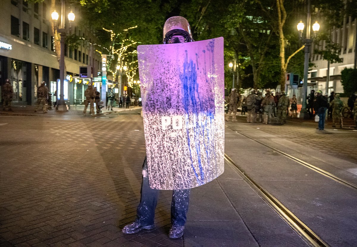 Right before they cleared out, I spotted this shielded officer standing in the middle of the intersection, completely covered in purple paint.