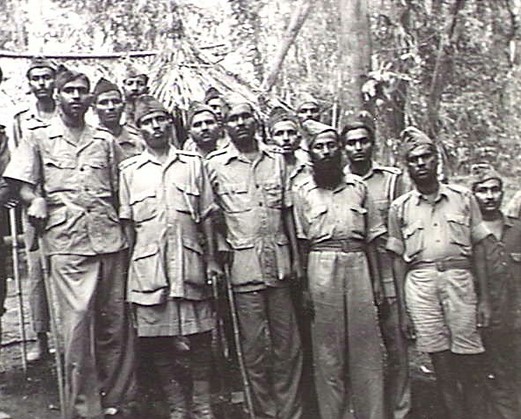 2/9: A group of malnourished junior Officers of the 1st Hyderabad State Regiment. Note the walking sticks to aid movement. Many of the older men had not survived the rigors of captivity. All men were occupied in heavy work building Japanese tunnels, bunkers and gun emplacements.