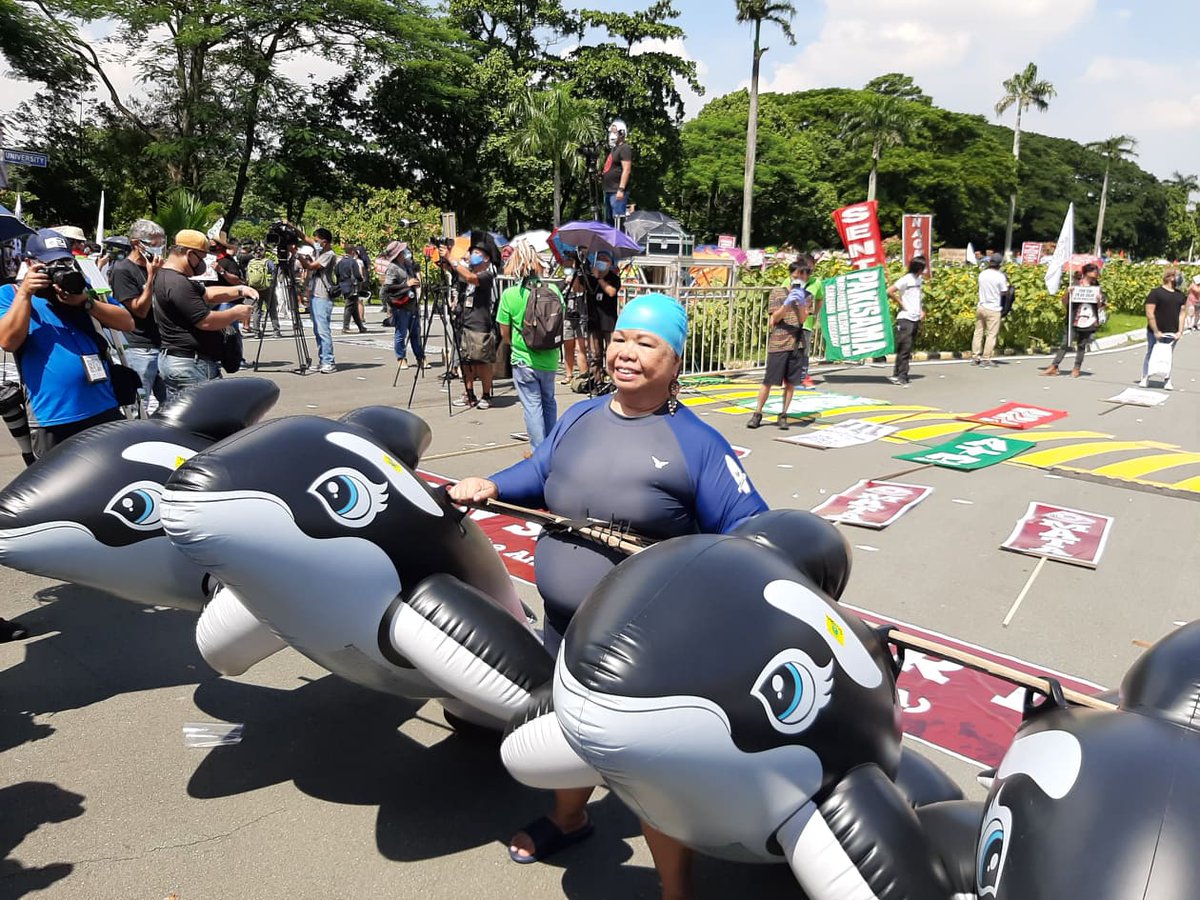 ABSCBNNews's tweet photo. Matapos mag-ala Debold Sinas sa "Grand Mañanita" protest sa UP Diliman noong Hunyo 12, tila ginaya naman ng aktibistang si Juana Change ang litrato ni Pres'l spokesman Harry Roque kasama ang ilang dolphins sa Subic sa #SONA2020 rally ngayong Lunes. | Davinci Maru, ABS-CBN News https://t.co/8MSDEj8bdD