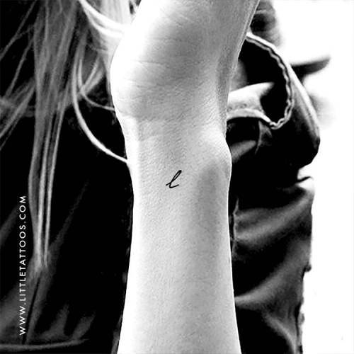 Minimalist letter L tattoo located on the wrist