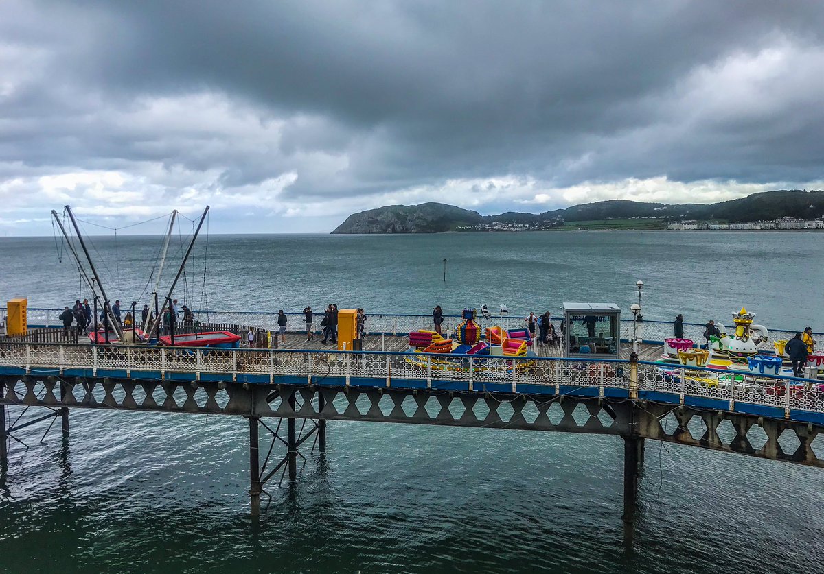 NorthShorePhoto's tweet photo. Dark clouds and kiddies rides... #Llandudno https://t.co/laJ9wD2ivk