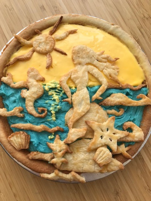 PieCloudCalgary's tweet photo. Please enjoy this addition to our summer mermaid/ocean theme that we made yesterday. The sunset is lemon, the ocean is marshmallow mermaid flavor filling, of course. #pie #pieart #mermaid https://t.co/HZc3I79hfz