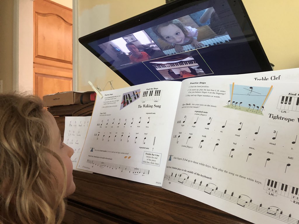 PianoMusing's tweet image. Here is a photo of my student and me in a remote lesson. My students usually use one or two devices. If only one, they either have to move it from the music stand to the edge/lip of the keyboard, or angle it downward like in this shot
