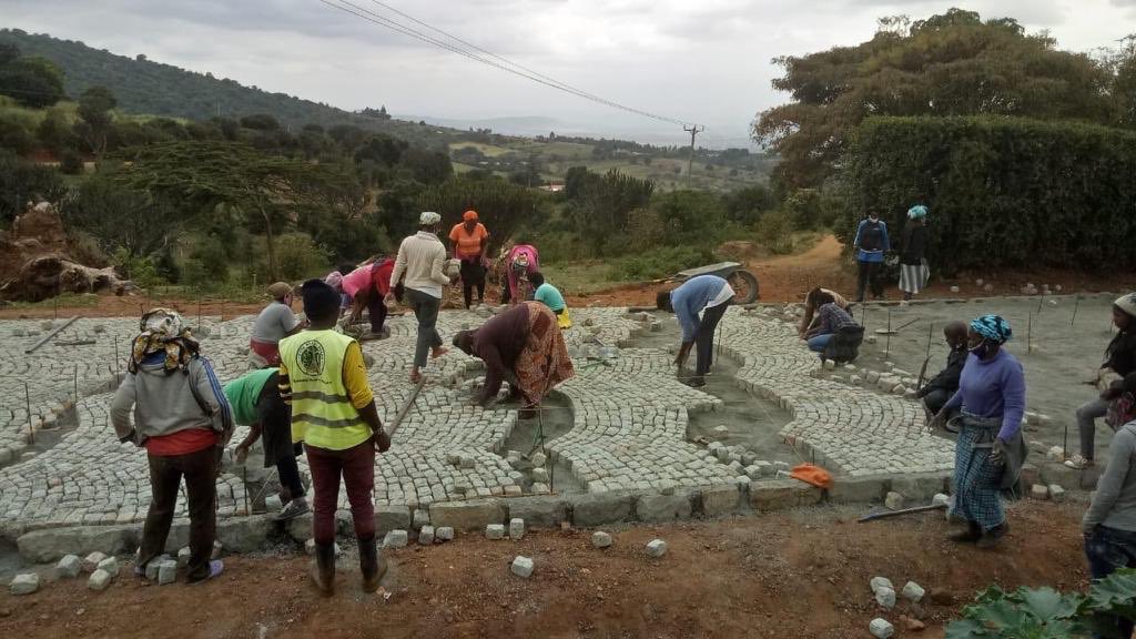 PSCharlesHinga's tweet photo. Kazi Mtaani phase 2 entail works beyond hygiene. Youths will be trained to build roads using cobblestones, below they are doing a pilot 1km road in Mua, Machakos using cobblestones. The future is to shift towards community contracting to guarantee them opportunities @PDUDelivery https://t.co/tbMsGDm38o