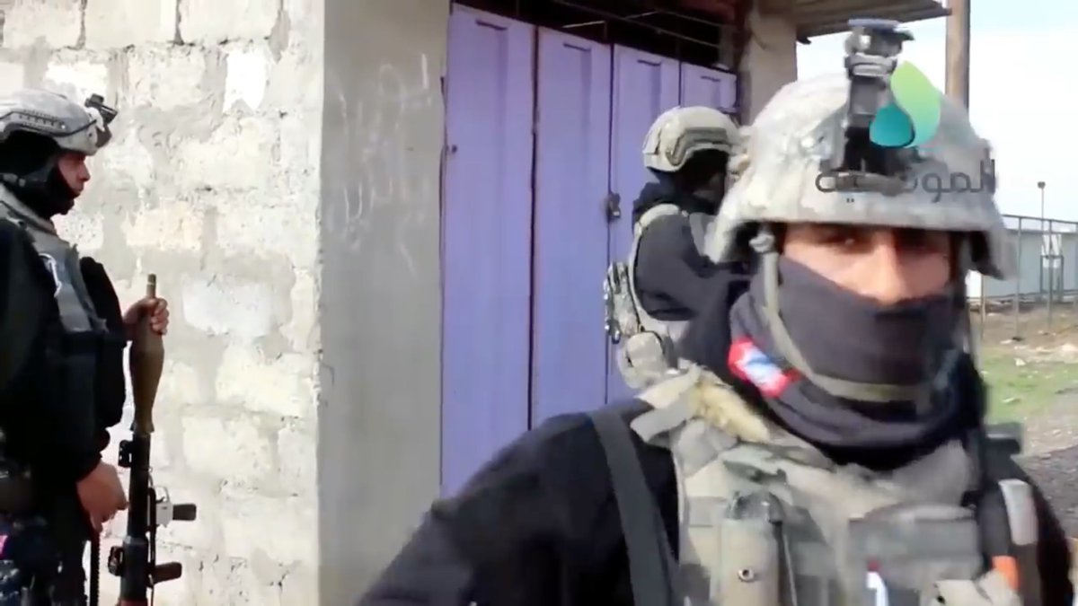 The cameraman is a federal police officer.Suddenly the man in the foreground makes eye contact with cameraman and unslings his rifle.