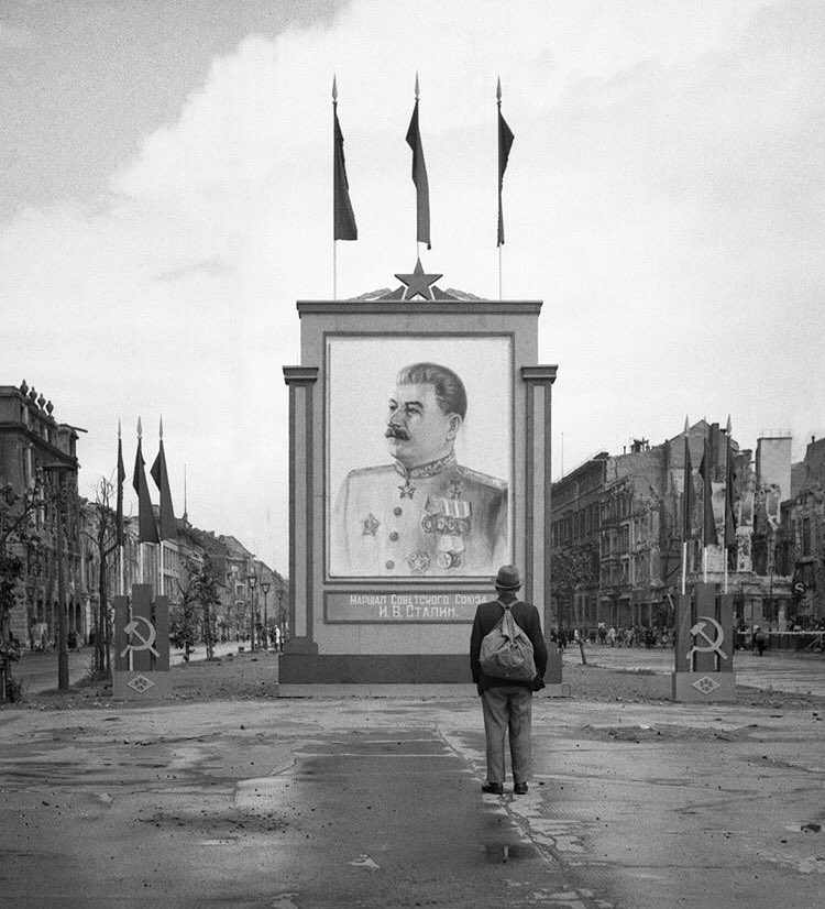A German civilian looks at a large poster portrait of Stalin on the Unter-den-Linden in Berlin, 3 June 1945.