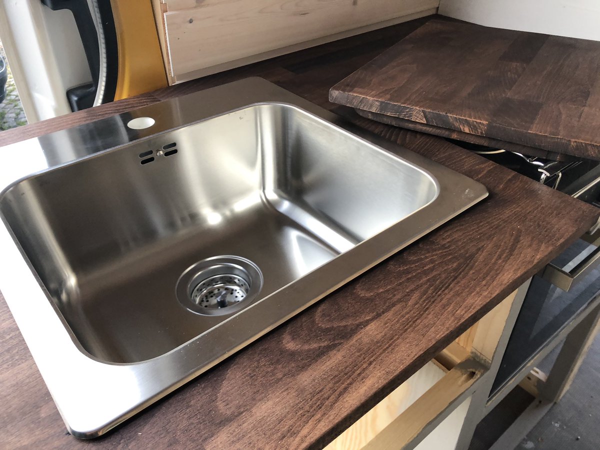 Update on tonight's progress. Stained the kitchen worktop and made this cool thing for the sink.