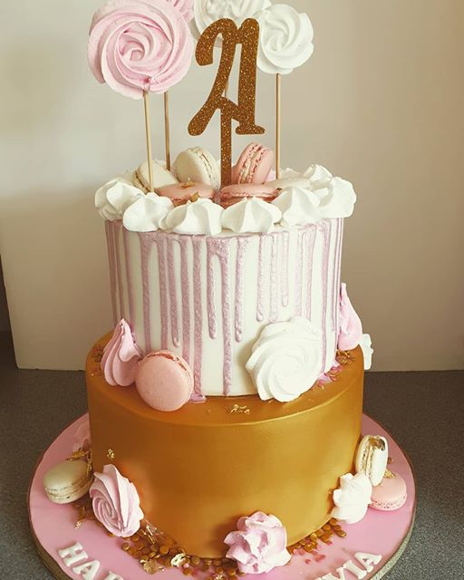 A two tiered 21st birthday cake with macarons and meringues for decoration #macarons #birthdaycake #meringues