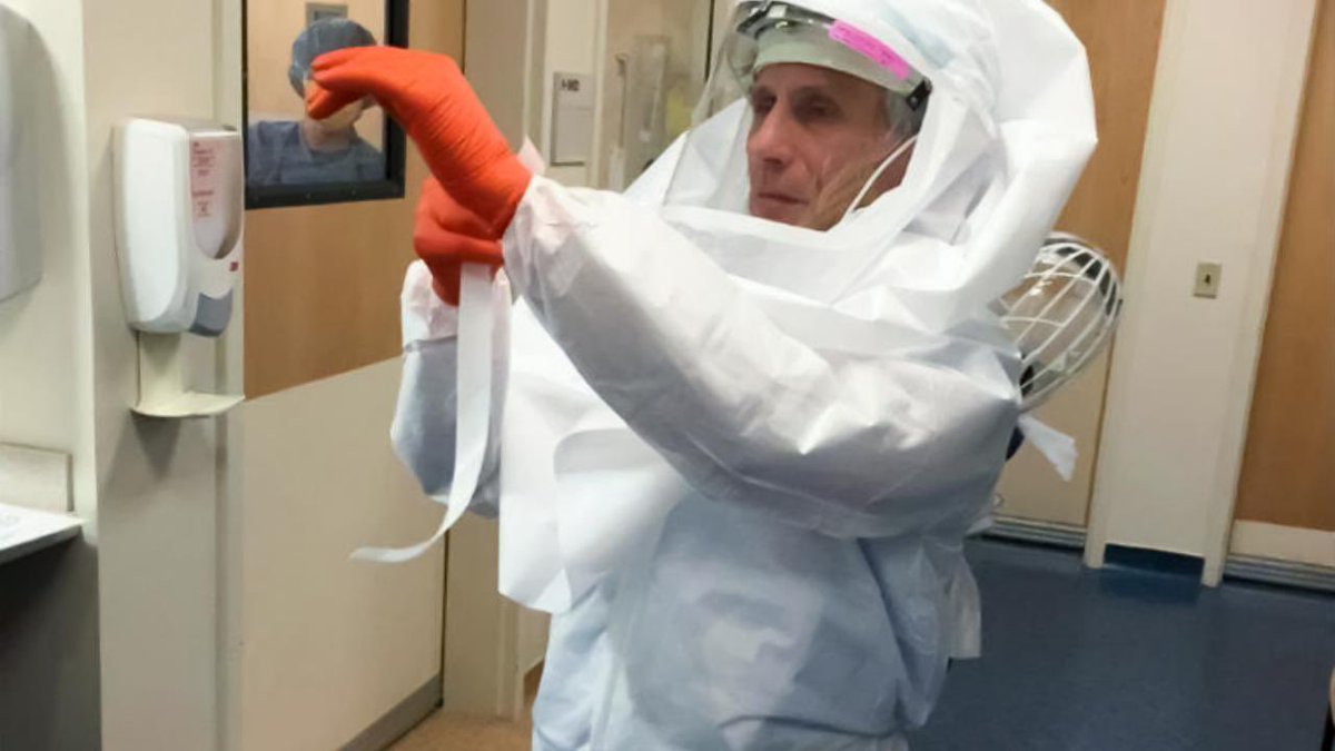 DrEricDing's tweet photo. Experts: It is too risky for a doctor who 74 years old to treat an Ebola patient!

Dr Fauci: Hold my beer 🍺 

➡️ Fauci dons full PPE suit to treat an Ebola patient himself (circa 2015)

This is TRUE LEADERSHIP. Trump and Navarro are cowards. 

https://t.co/u0TUwdy22W https://t.co/ddUvLWA2NF