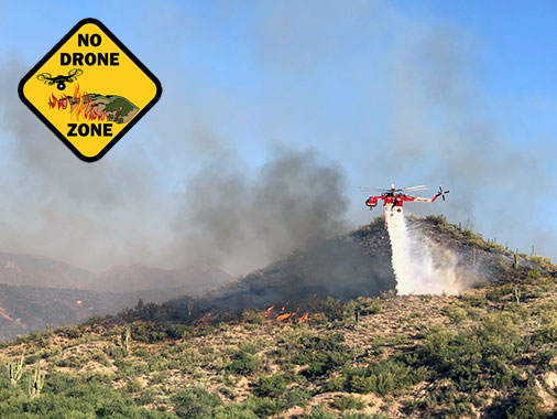 A helicopter drops water on the #BushFire in Arizona. Photo by Tonto National Forest