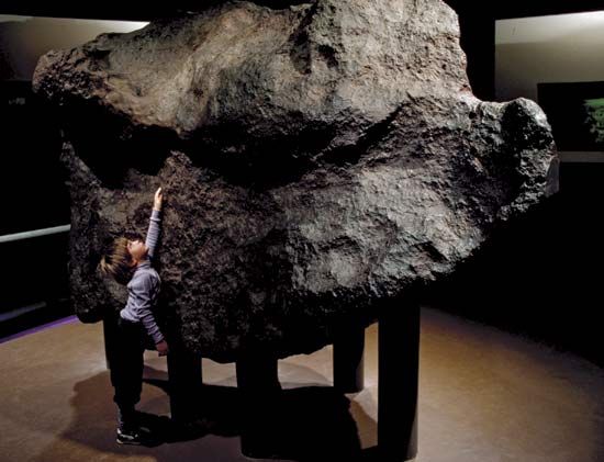 This is the Ahnighito Meteorite, in the American Museum of Natural History (NYC). They invite visitors to touch this "object that is nearly as old as the Sun. Discovered in 1894 in Greenland, this iron meteorite slammed into Earth some 10,000 years ago."  https://www.amnh.org/exhibitions/permanent/meteorites/meteorites/ahnighito