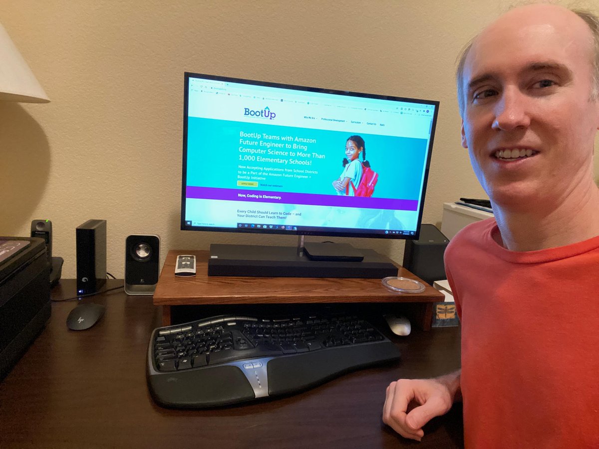 Ryan North smiling with computer in the background