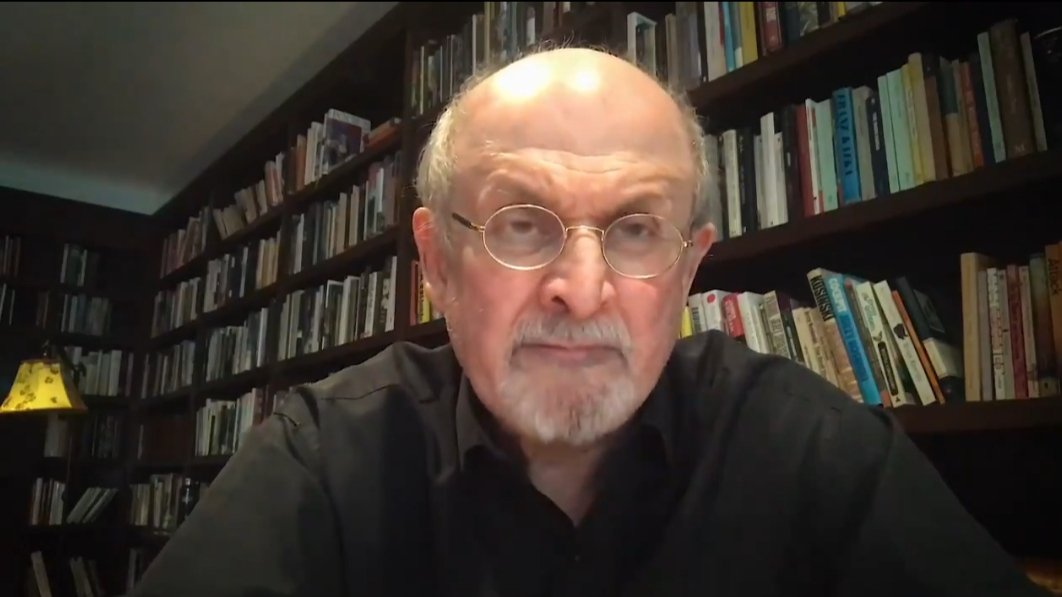 BCredibility's tweet photo. Salman Rushdie gives us a long, sombre bookcase thundering past like a great goods train filled with credibility. His dome is bathed in the glow of understanding. A lamp pops brilliantly in the distance. Salman's lesson is that thought illuminates fact. Without it, all is murky. https://t.co/AAMxQJaP0y