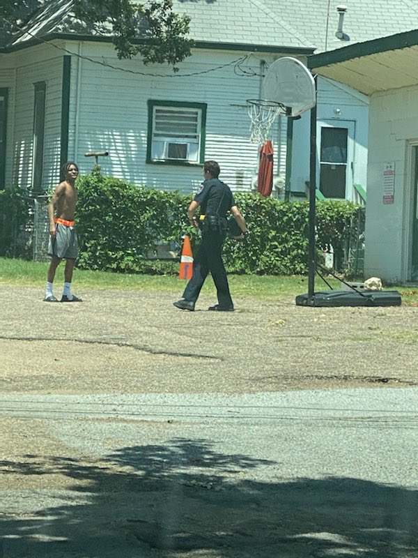 ArlingtonPD's tweet photo. Officer Trevor Lawson assigned to North District Patrol was finishing a report on Oak Street when he saw this teen playing some basketball and joined in. 

Thank you to the citizen who sent these pics in. #ServiceBeforeSelf #HonorAboveAll https://t.co/Lgix6bK1r1