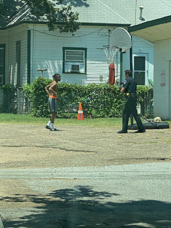 ArlingtonPD's tweet photo. Officer Trevor Lawson assigned to North District Patrol was finishing a report on Oak Street when he saw this teen playing some basketball and joined in. 

Thank you to the citizen who sent these pics in. #ServiceBeforeSelf #HonorAboveAll https://t.co/Lgix6bK1r1