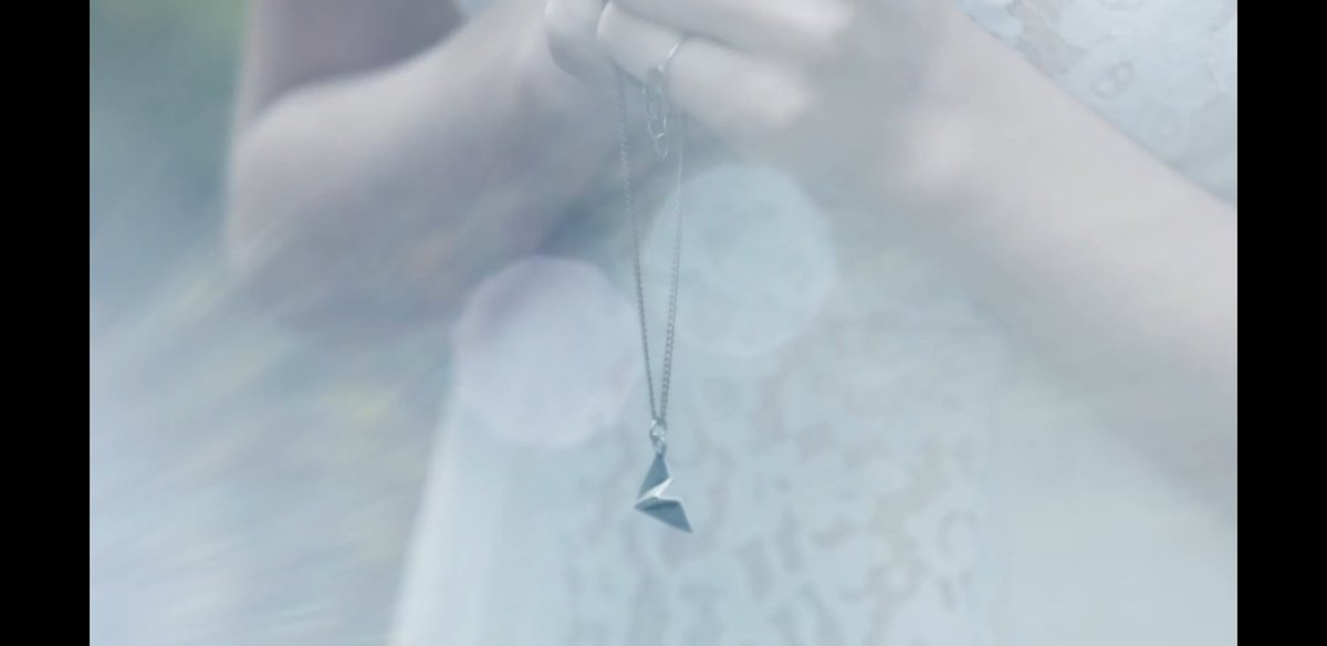 Although she was not wearing the exact same necklace in the 'Out Of The Woods' music video, she was seen holding it in the 'Style' music video.