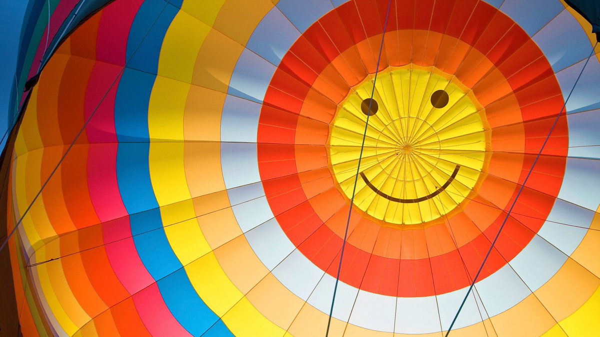The inside of a hot air balloon, which has a smiley face at the top. 