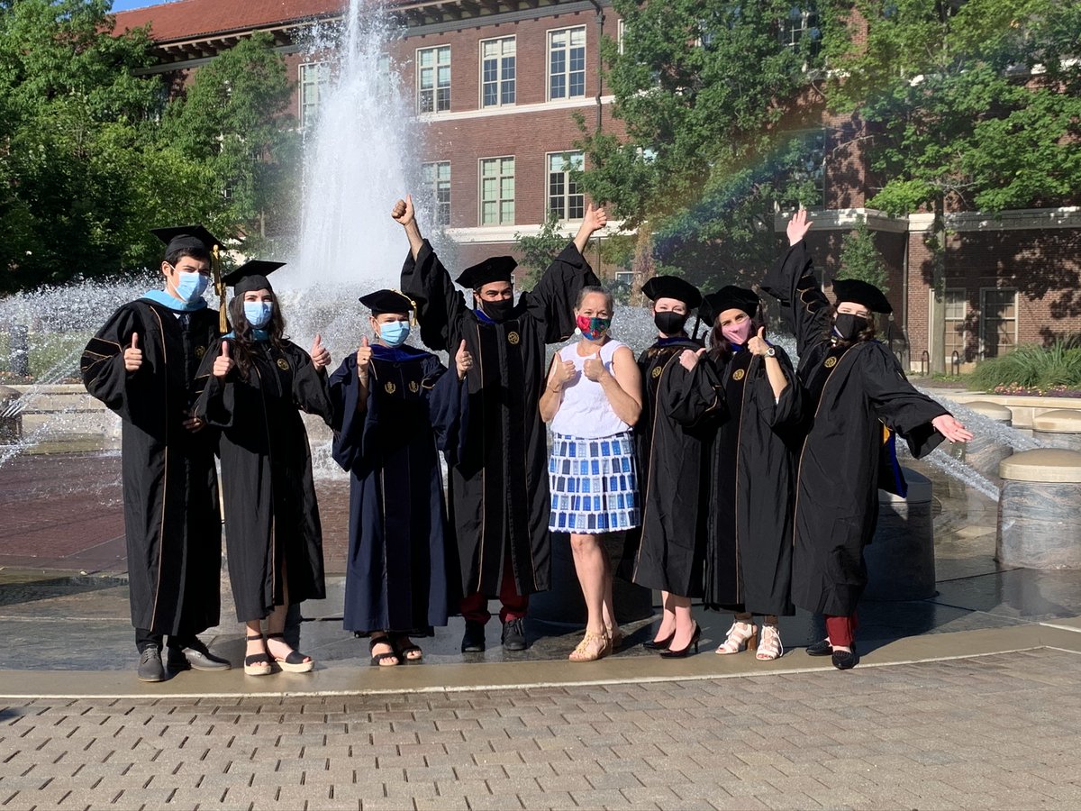 PurdueEDU's tweet photo. Marcia Gentry, professor of educational psychology and director of the Gifted Education Resource Center, celebrates with her masked PhD and master’s graduates outside Beering Hall. Congratulations to them and all of our August graduates! #PurdueWeDidit #purdueuniversity https://t.co/Ogdp5iT02j