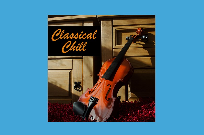 a photo of a violin set up against a dresser drawer on the ground