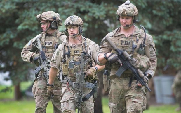 I *do* think these guys would benefit from having their organization patch on their chests, rather than just "police." Below is an FBI SWAT team. It's clear who they are. 5/