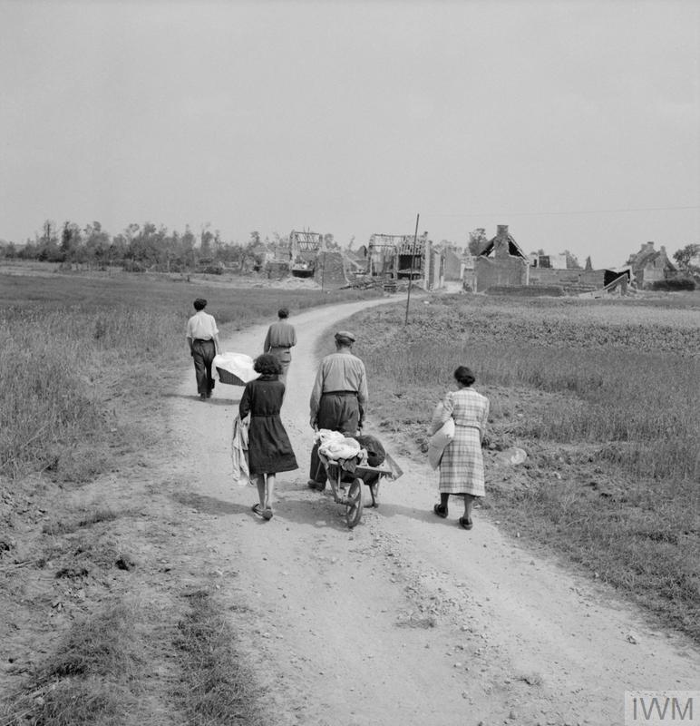 6thairborne's tweet photo. "A French family returns to their village, Buron, north-west of Caen, which was completely wrecked during the fighting, 18th July 1944." #OTD https://t.co/sWd1fCDeZ5