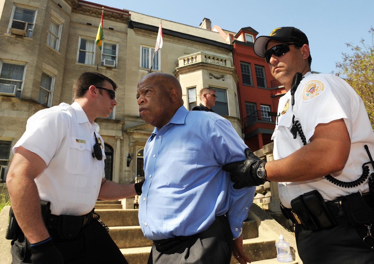 John Lewis is led away in handcuffs by a Secret Service officer in Washington, DC in April 2009 as he protested Sudan's Darfur conflict. Photo by Tim Sloan.  #GoodTrouble  #JohnLewisRIP