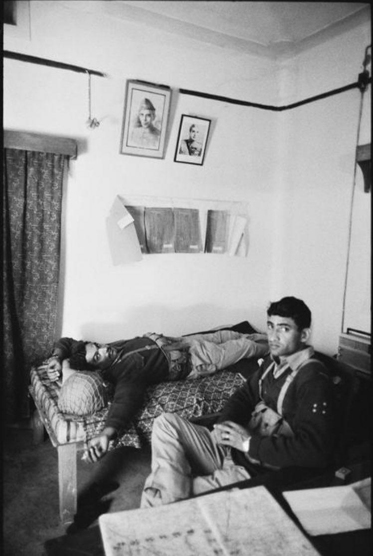 EAST PAKISTAN. Thakergaon. Two Pakistani soldiers at rest after knocking down the Indian Troops. On the wall are portraits of Muhammad Ali JINNAH (left), the father of the nation, and Pakistani President.(6/20)